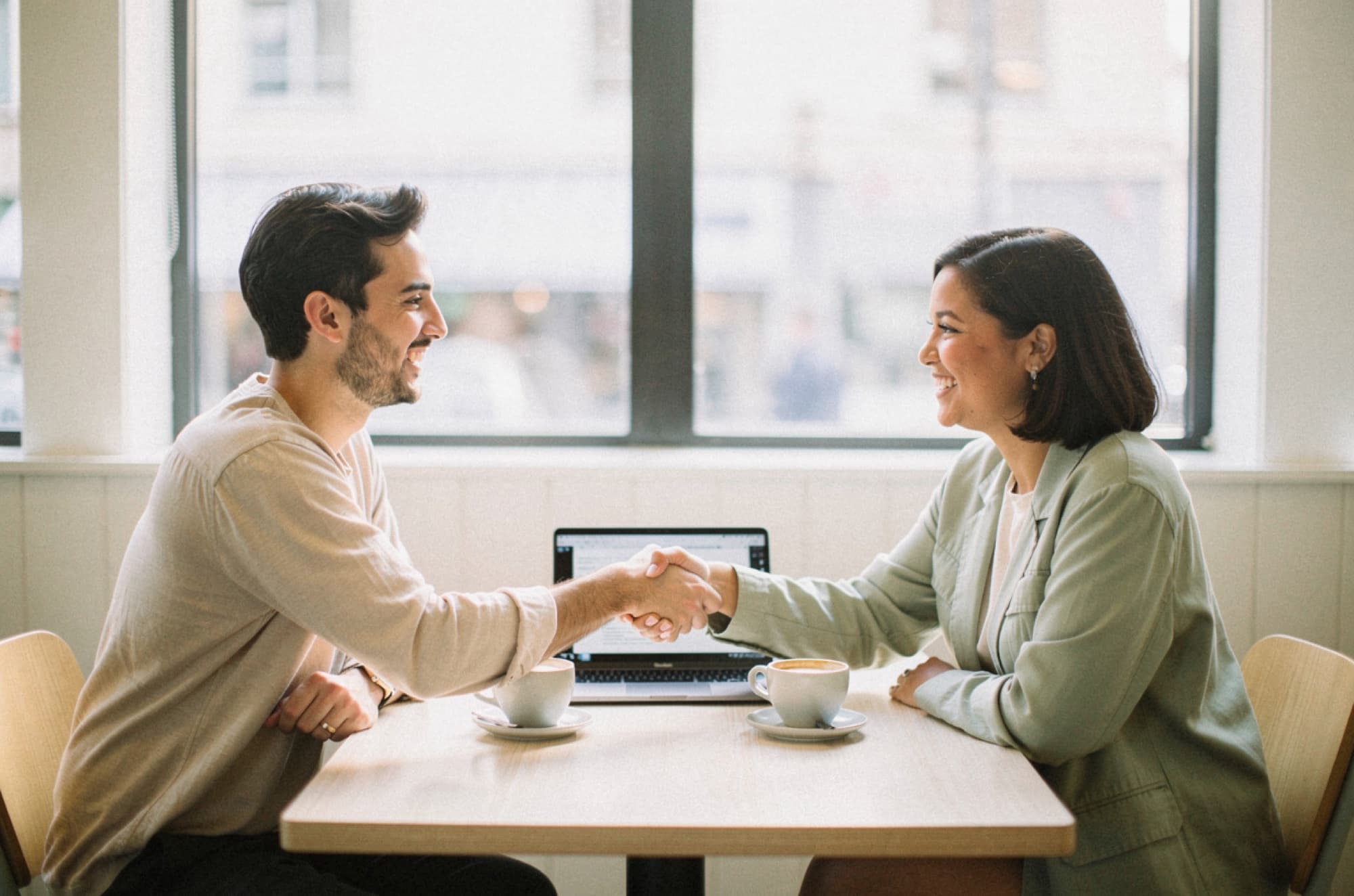 A publisher and a brand owner shaking hands on terms they agreed between themselves