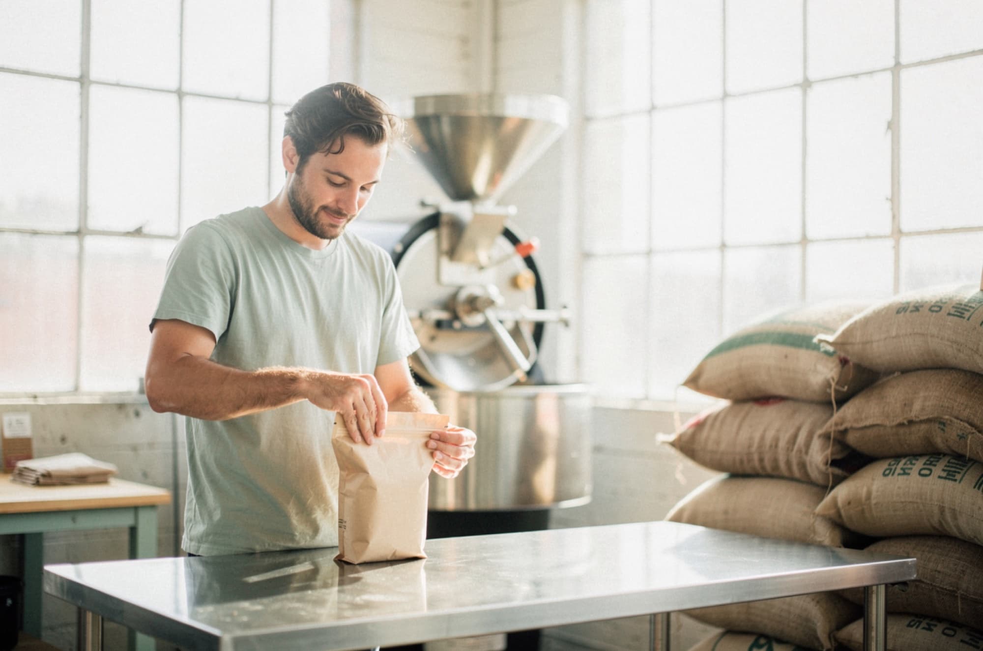 A coffee roastery owner bagging beans for online orders